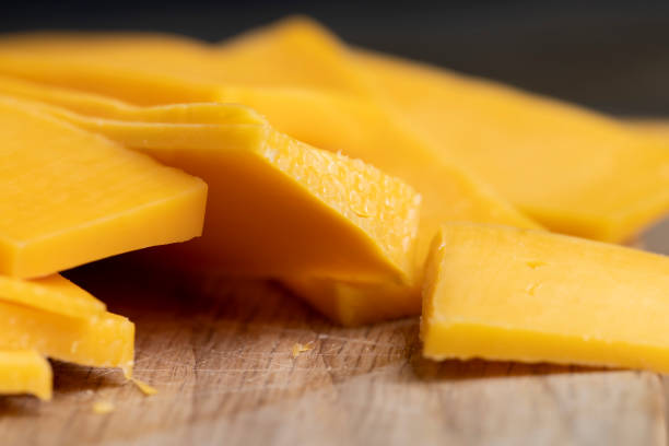 istock slicing yellow cheese close-up 2194700015