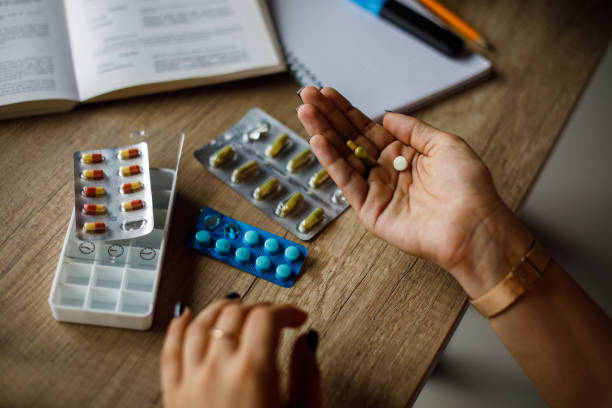 istock Young woman taking her meds 2194700781