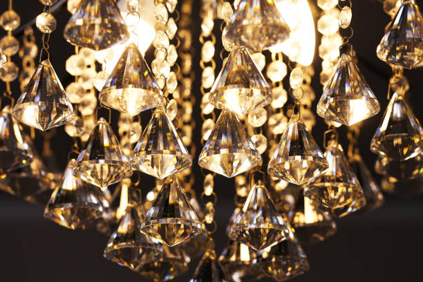 istock Luxurious illuminated crystal chandelier with diamond shaped decoration. Glamorous design for upscale interiors. 2194701805