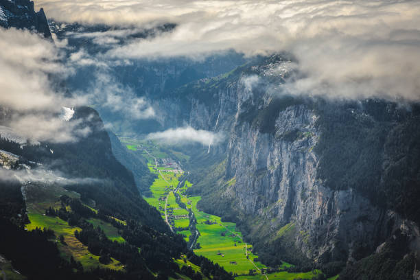 Majestic view with green fields in the misty Lauterbrunnen valley, Mannlichen, Grindelwald, Bernese Oberland, Switzerland, Europe