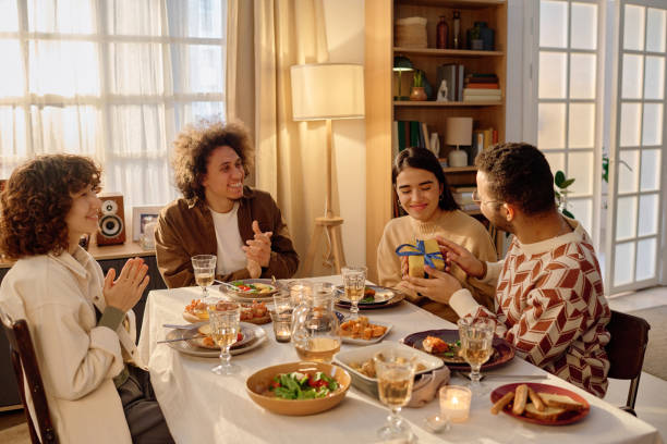 istock Friends Clapping Hands while Couple Exchanging Gifts 2194702229