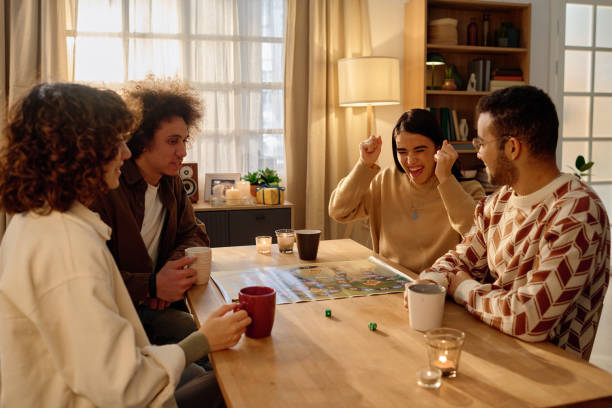 istock Woman Happy about Dice Roll Result 2194702315