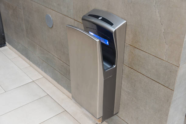 istock An automatic hand dryer is mounted on a bathroom wall, promoting hygiene and convenience for users after washing their hands 2194702980