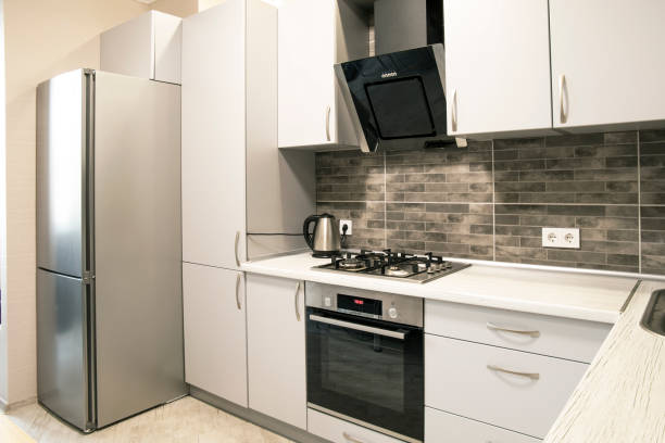 istock Modern small kitchen with grey brick tiles and grey cabinets 2194703690