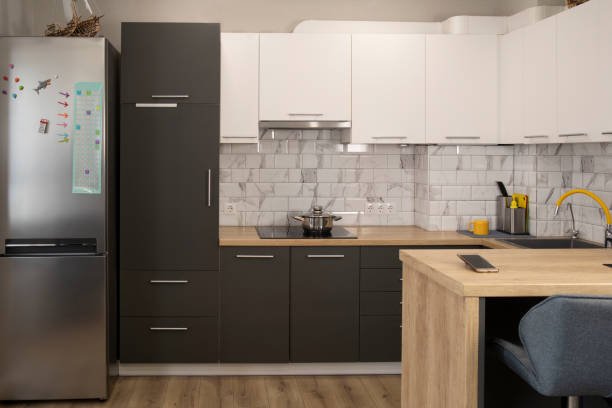 istock Modern and stylish white and grey kitchen with wooden bar counter 2194703720