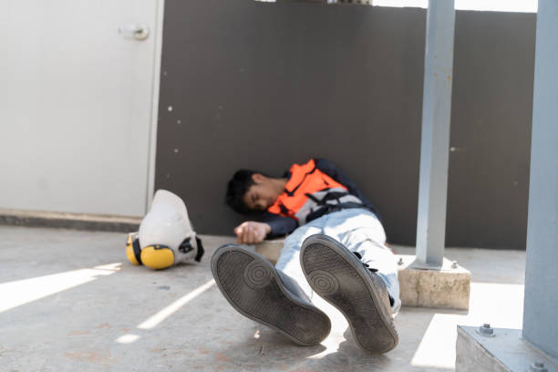 istock Asian male worker have accident at construction site. Construction builder worker feeling sick, have a headache at work site. Health safe of work and safety first concept 2194704319