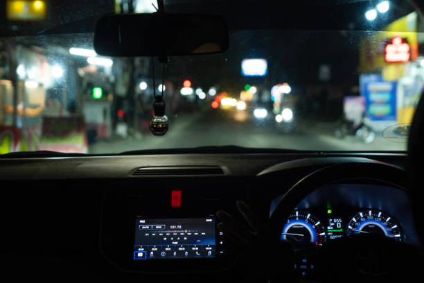 istock car dashboard showing digital radio on screen with blurry street light 2194704884