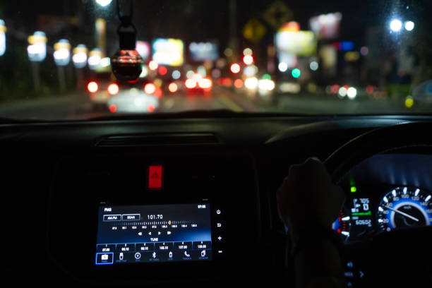 istock car dashboard showing digital radio on screen with blurry street light 2194704885