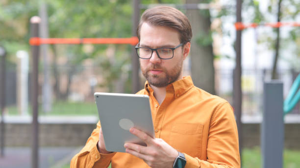 istock Portrait of Young Man Using Tablet Outdoor 2194705731