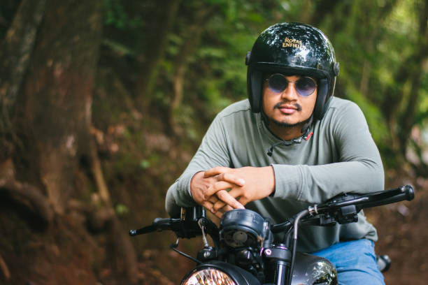 Dandeli, Karnataka-3rd november 2023:Biker sitting on a Royal enfield hunter 350 motorcycle.