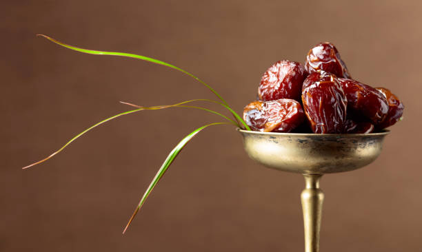 istock Closeup of sweet dates in brass dish. 2194705810