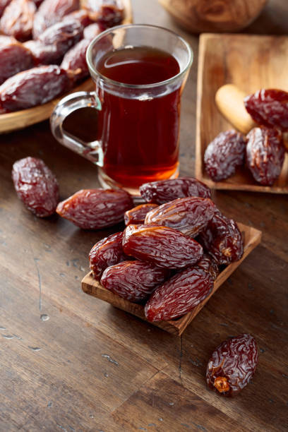 istock Tea and dates on a old wooden table. 2194705831
