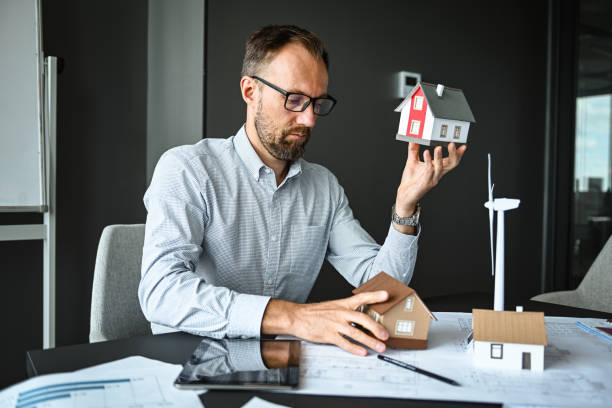 istock architect engineer in office thinking about house construction project and alternative energy 2194705896