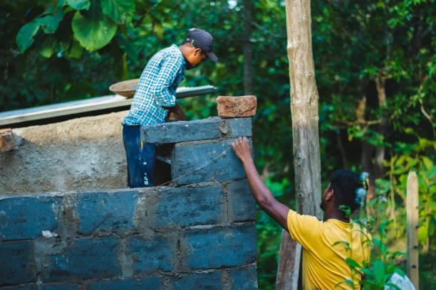Dandeli, Karnataka-3rd november 2023: workers working on a brick wall at construction site in the village.