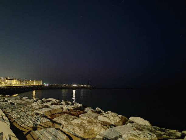 istock Calm Sea and Rocks by night 2194706866
