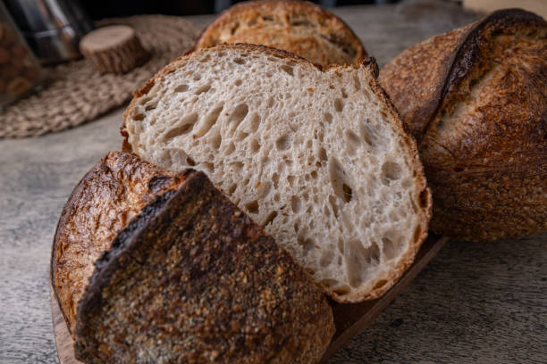 istock Golden-Crusted Artisan Sourdough Bread on a Rustic Wooden Table. 2194707742