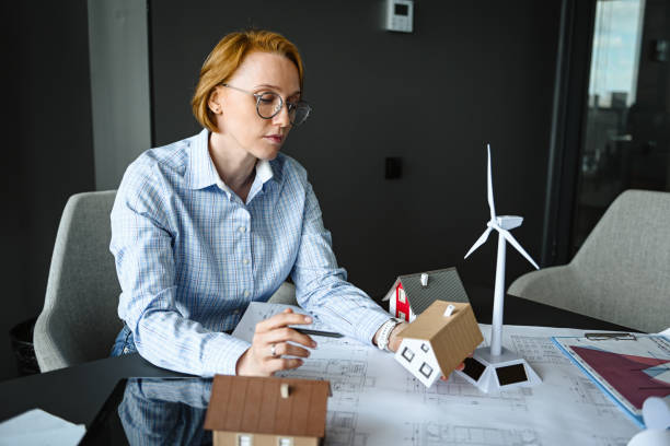 istock architect engineer in office thinking about house construction project and alternative energy 2194709314