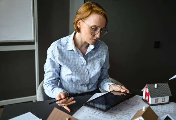 istock architect engineer in office thinking about house construction project and alternative energy 2194711320