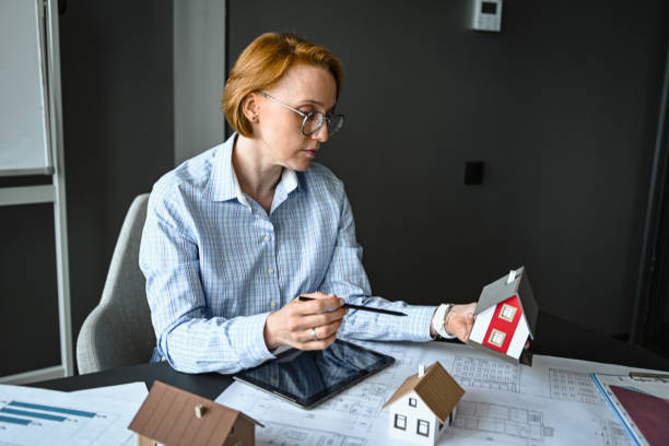 istock architect engineer in office thinking about house construction project and alternative energy 2194712324