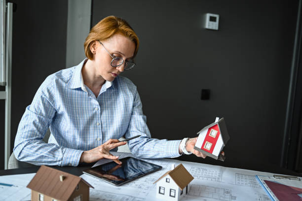 architect engineer in office thinking about house construction project and alternative energy