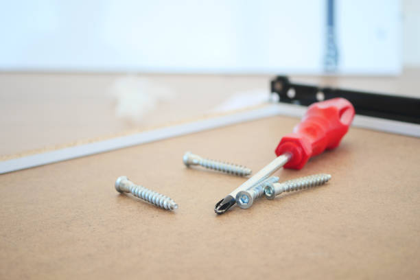 Essential tools for DIY a screwdriver with assorted screws organized on a workbench