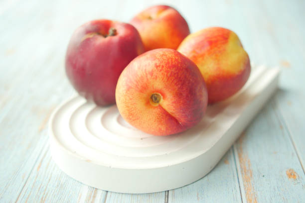A stunning arrangement of apples on a stylish white dish against a light backdrop.