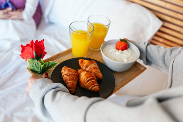 istock Woman bringing breakfast in bed to her partner on valentine's day 2194714942