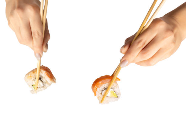 istock Sushi with salmon in a woman hand isolated. 2194716343