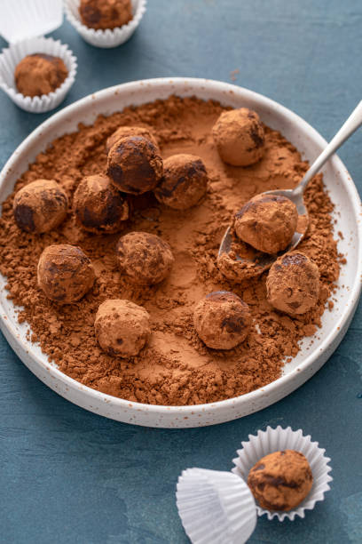 istock Artisanal chocolate truffles dusted with cocoa powder on a plate with a spoon 2194717707
