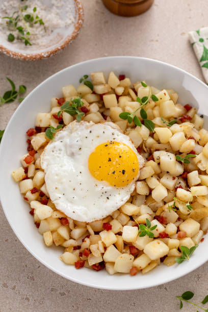 istock Classic breakfast potato hash with fried egg and ham or bacon 2194717743