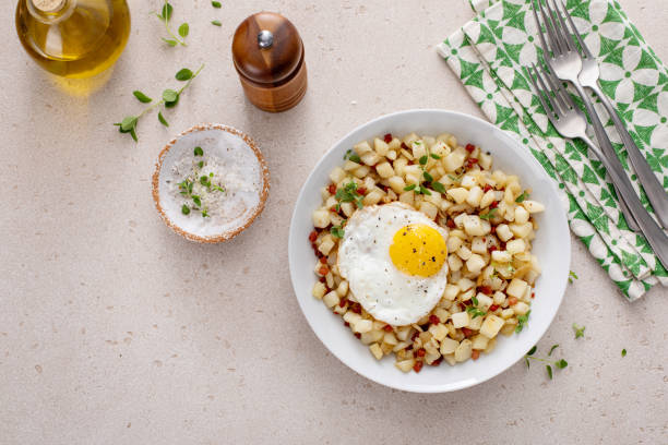 istock Classic breakfast potato hash with fried egg and ham or bacon 2194717751