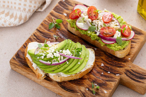 istock Fresh avocado toasts on wooden board 2194717814