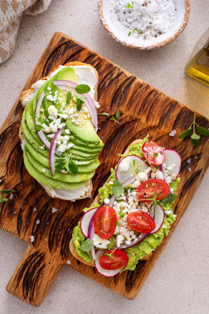 istock Fresh avocado toasts on wooden board 2194717815