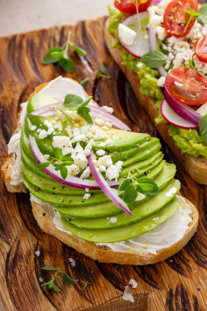 istock Fresh avocado toasts on wooden board 2194717820