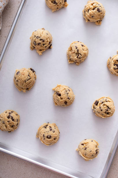 istock Scoops of cookie dough on baking sheet 2194717824