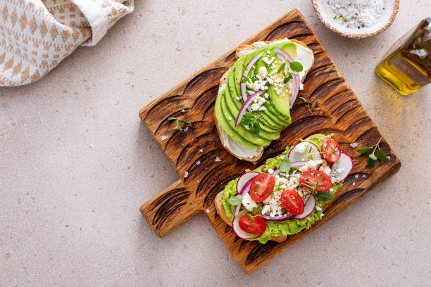 istock Fresh avocado toasts on wooden board 2194717839