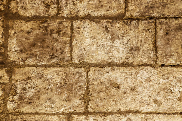 The rustic surface of a stone wall lining Malta's historic passageways