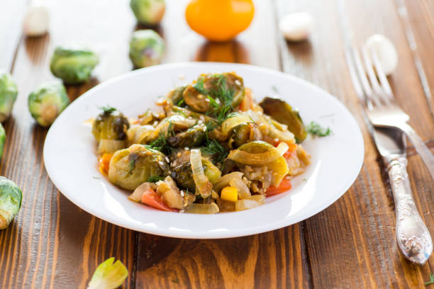 istock Brussel sprouts cooked with vegetables, on a wooden table 2194722842