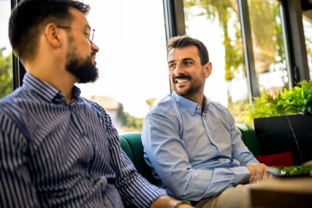 istock Two male friends hanging out at the caffe. 2194724661