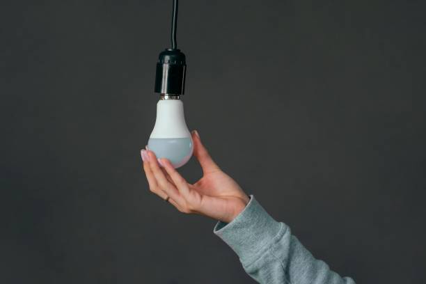istock changing light bulb in lamp at home. concept 2194724846