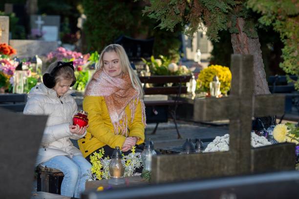 istock Women Engaging in Reflective Thought within a Tranquil Cemetery Setting Amidst Nature 2194725250