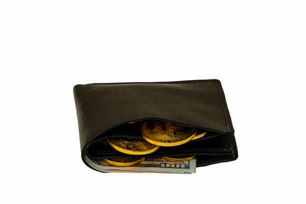 A black wallet is slightly opened, showing several gold coins and a stack of cash in U.S. dollar bills, emphasizing the concept of saving money.