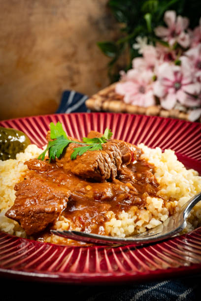 istock Chunky beef stew with savory sauce, served with bulgur groats. 2194727059