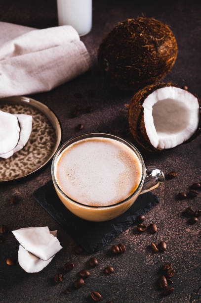 istock Cup of iced coconut coffee, coconut pulp and coffee beans on table vertical view 2194727068