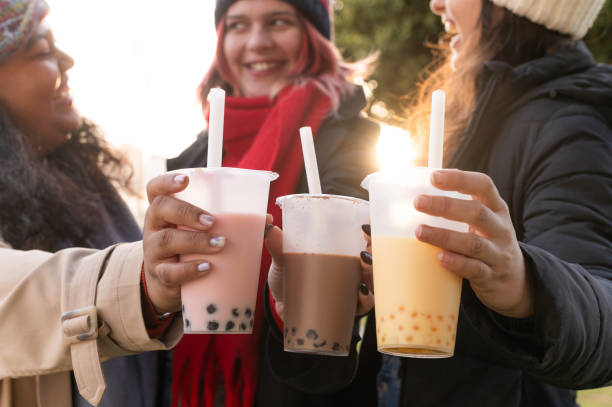 istock Three young women holding bubble tea and smiling at sunset 2194727403