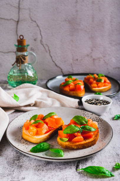 istock Appetizing bruschetta with tomatoes, garlic and basil on a plate on the table vertical view 2194727645