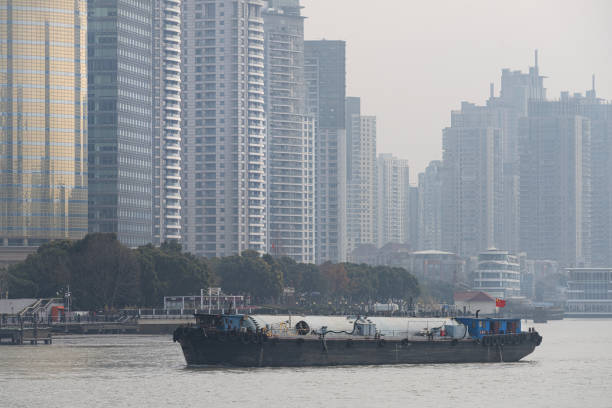 Shanghai, China. January 7, 2025. cargo ships transiting the Huangpu River in the city center