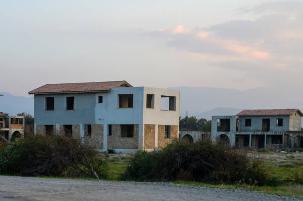 istock Deserted buildings stand quietly under a soft sunset sky in a forgotten development 2194728199