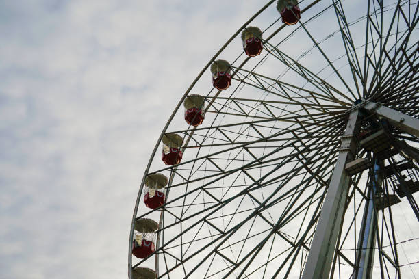 istock Vintage Ferris Wheel Against a Cloudy Sky 2194728346
