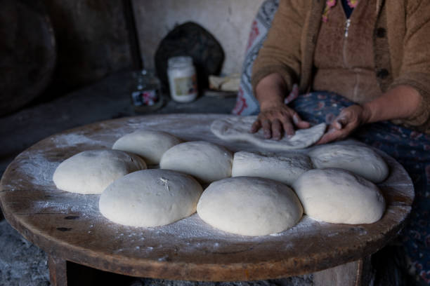 istock Elderly woman preparing dough for traditional bread making 2194730005